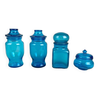 4 advertising jars in molded blue glass from the 70s