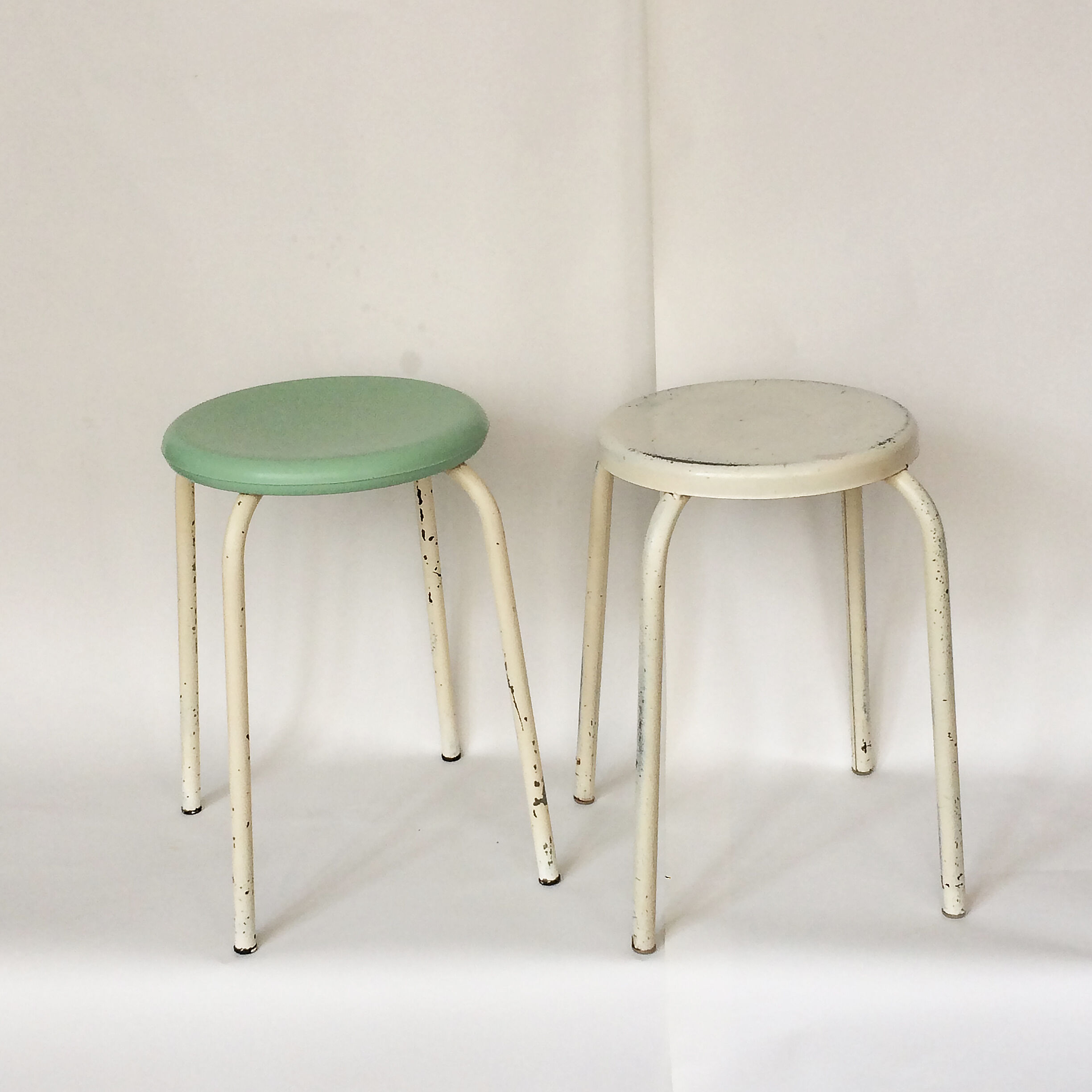 Two white and mint green stools