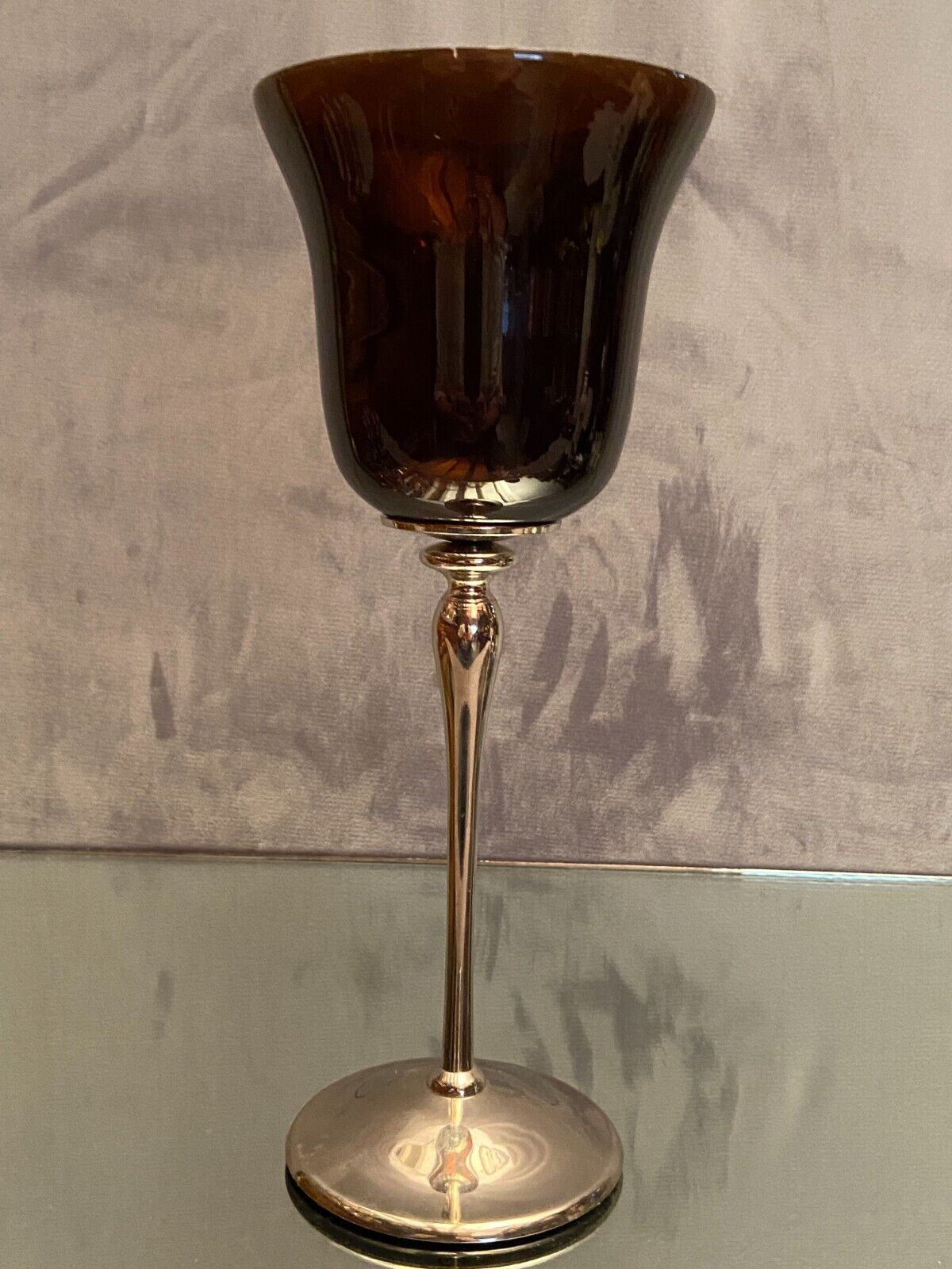 Tinted glass photophore on high metal foot with silver patina