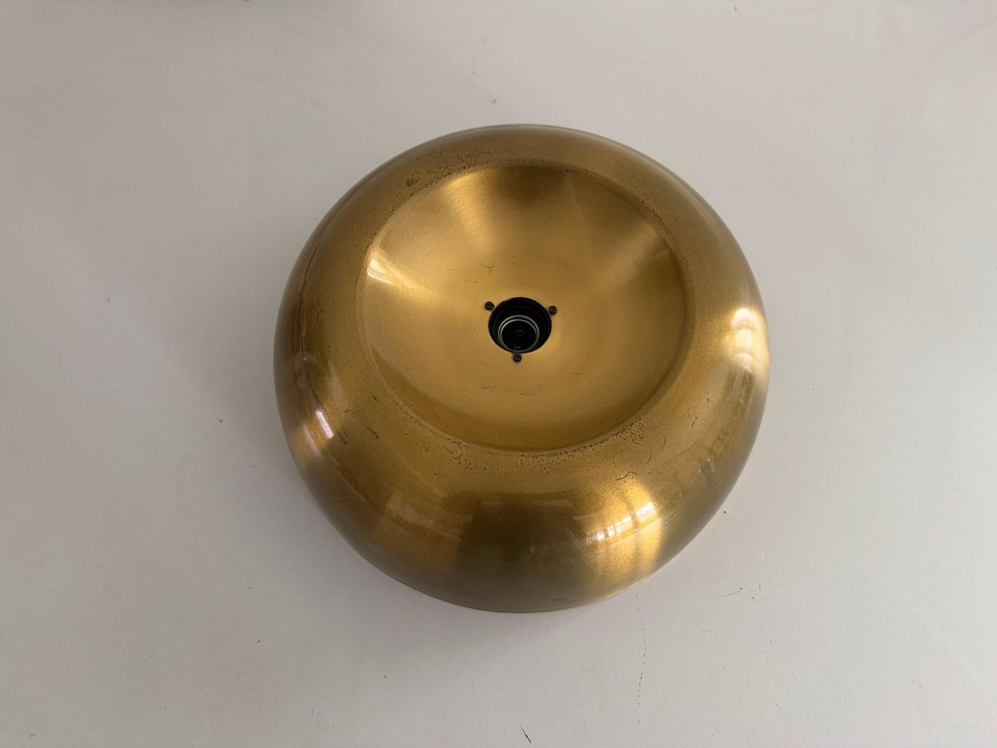 Flush-mounted disc-shaped brass fixture from the mid-century, 1960, Italy.