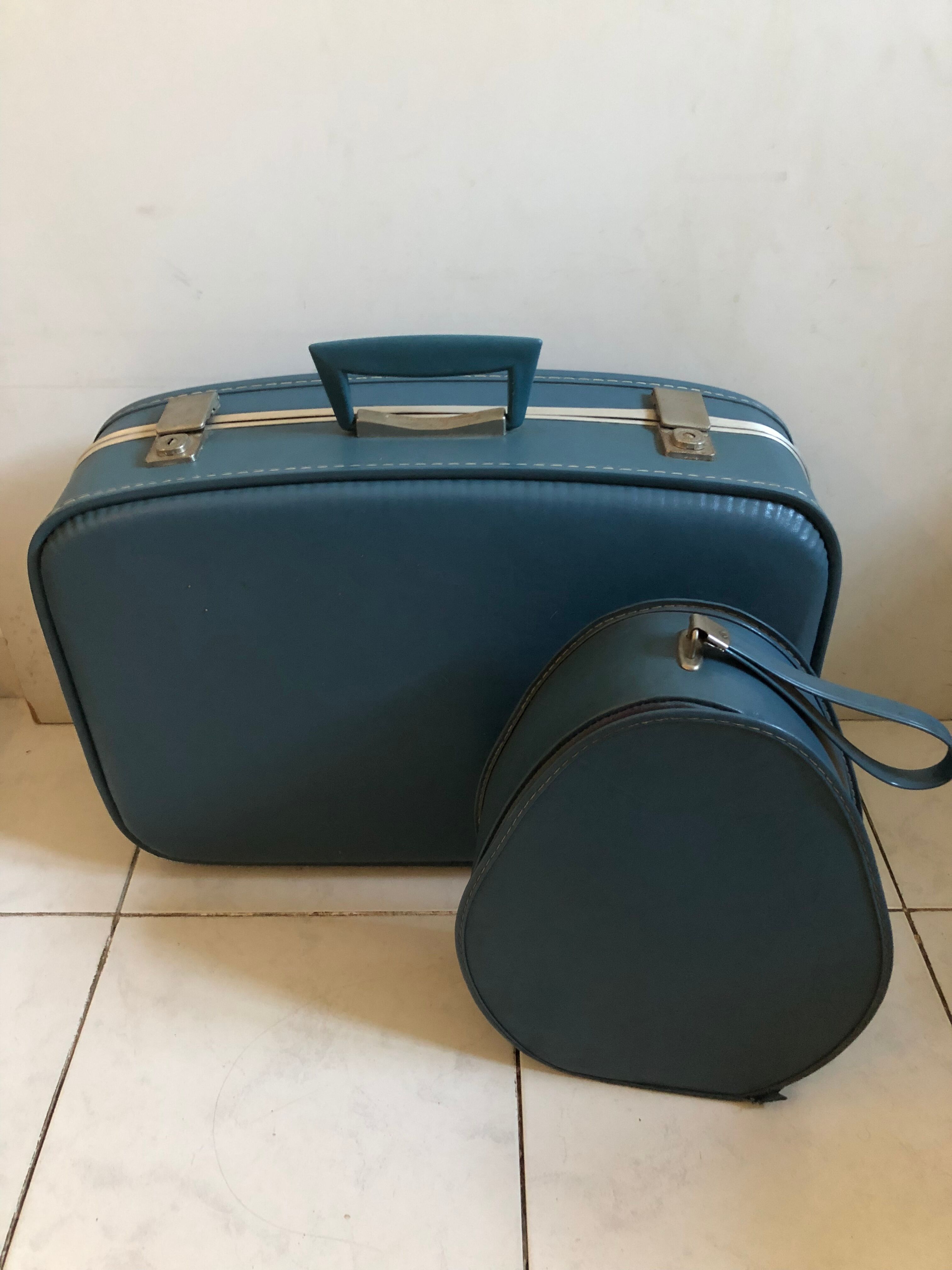 Suitcase has an air hostess hat