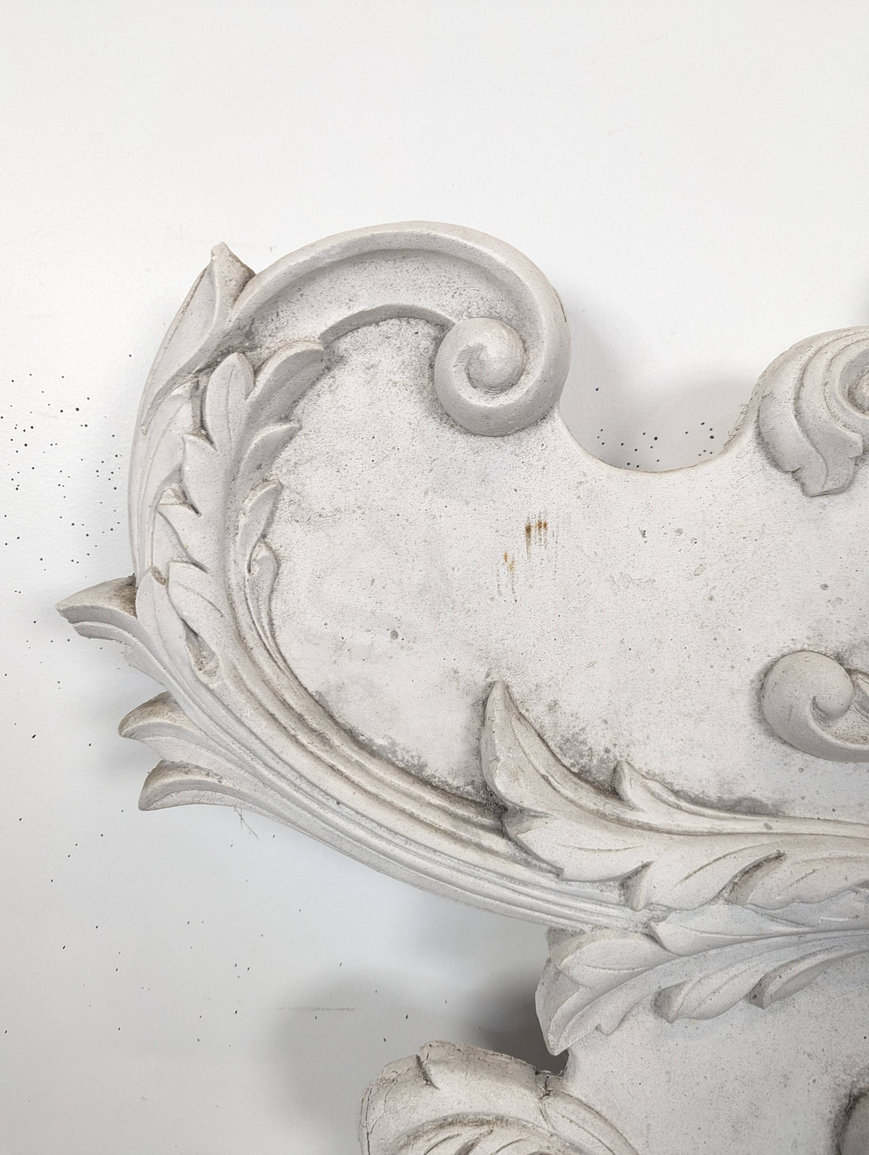 Large rococo fronton in stucco and carved wood, patinated white with an oculus.