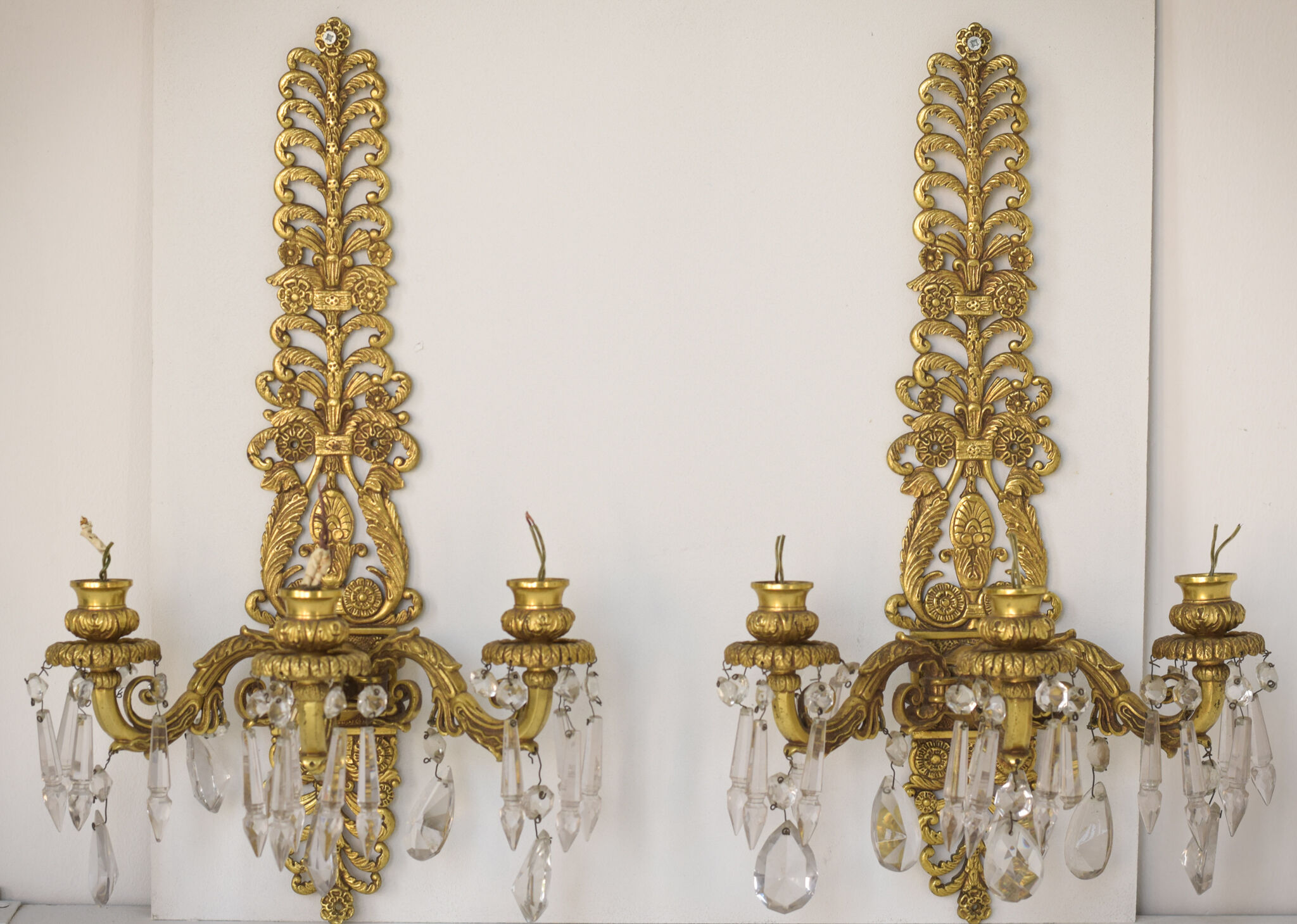 Two bronze and cut glass wall-mounted chandeliers