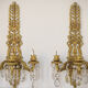 Two bronze and cut glass wall-mounted chandeliers
