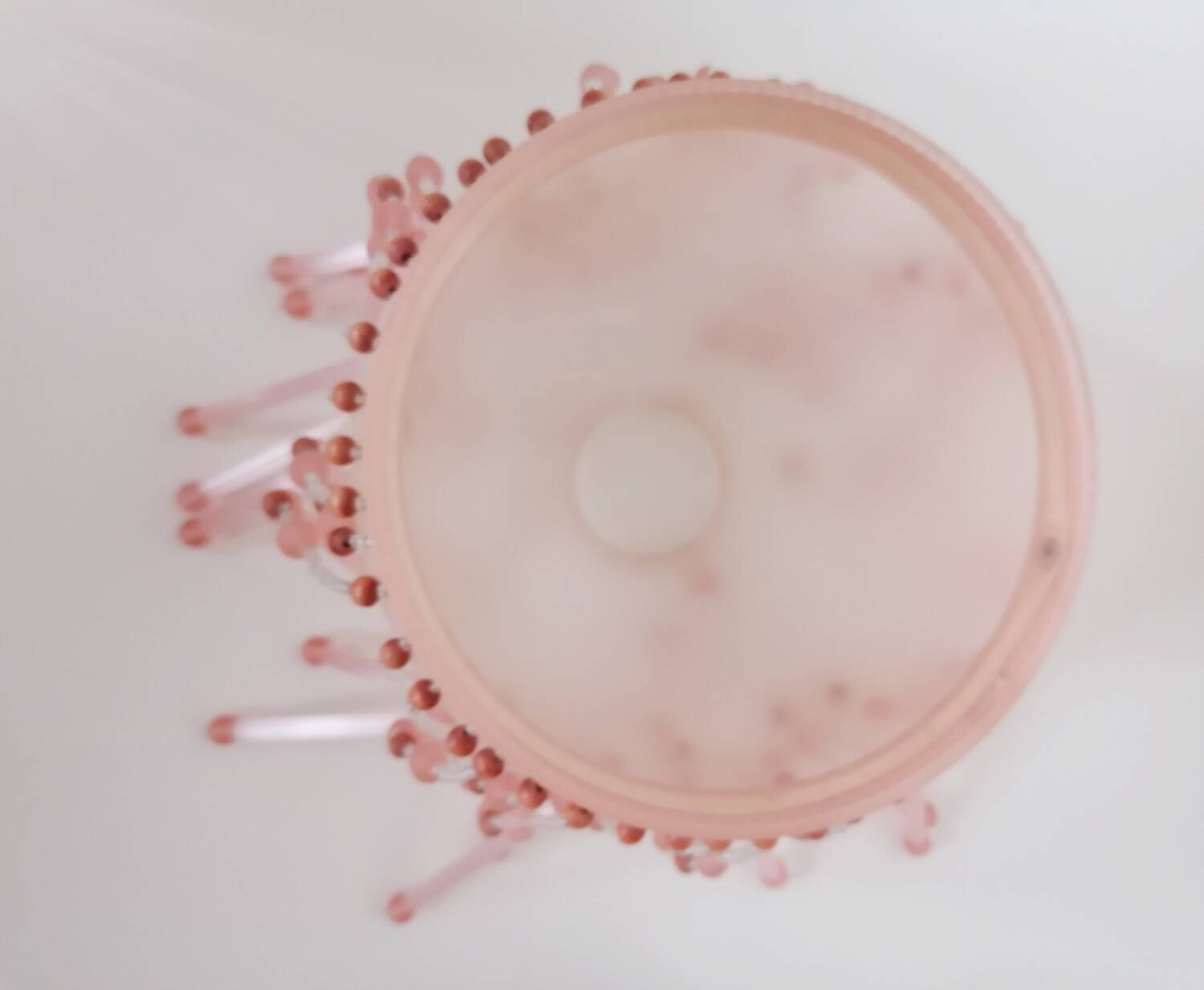 Pink glass wall lamp with garland of pearls