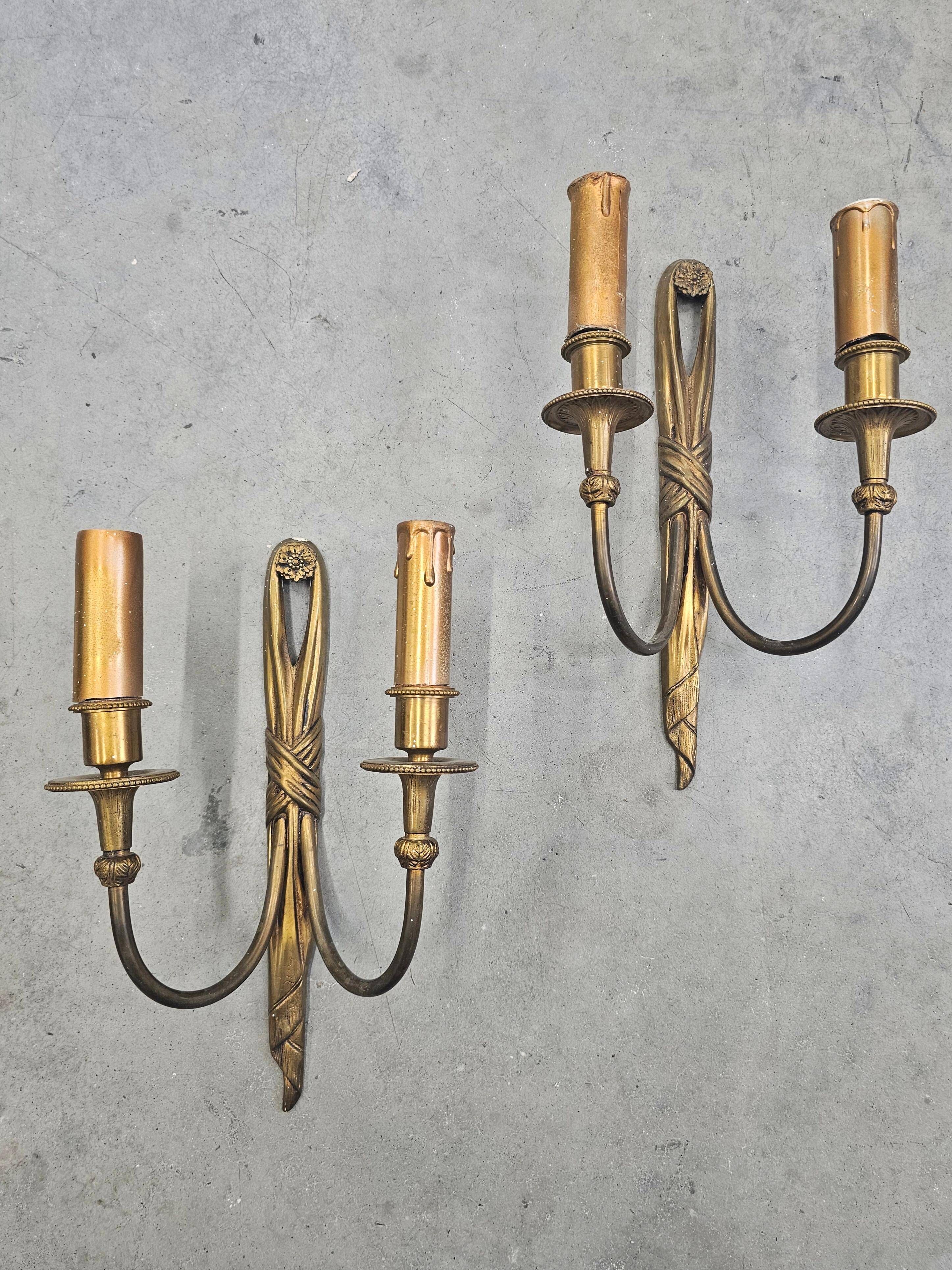 Pair of Louis XVI style bronze wall sconces with bow and tassel, 1940s.