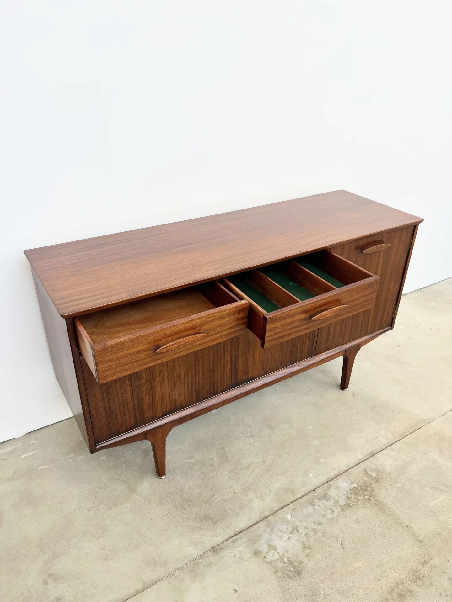 Teak Jentique sideboard — 1 door, 2 drawers & drop-down bar, England 1950s-60s