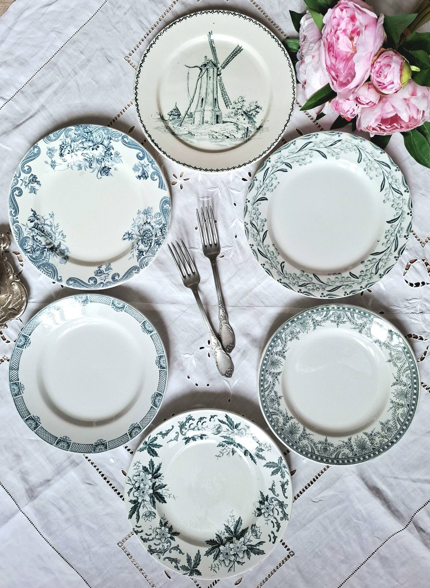 Old mismatched flat plates made of ironstone earthenware.