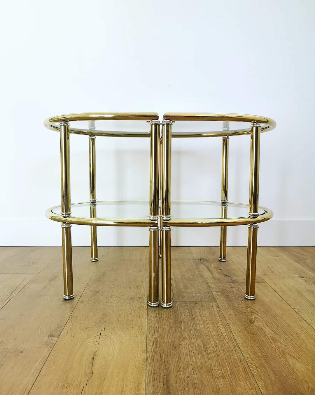 Pairs of gilded metal bedside tables and glass tops