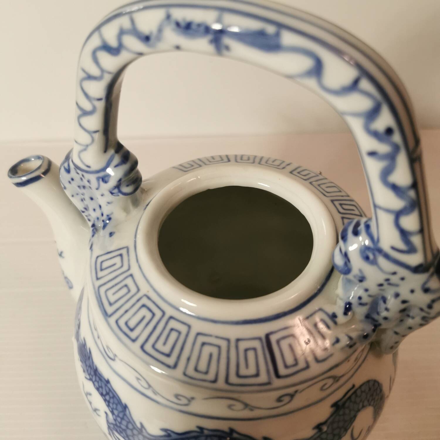 Old Chinese blue and white teapot in vintage ceramic with dragon decor