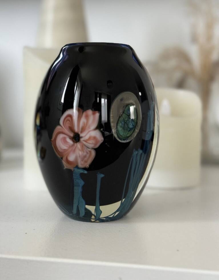 Double-lined blown glass vase with flower inclusions.