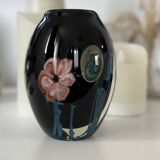 Double-lined blown glass vase with flower inclusions.