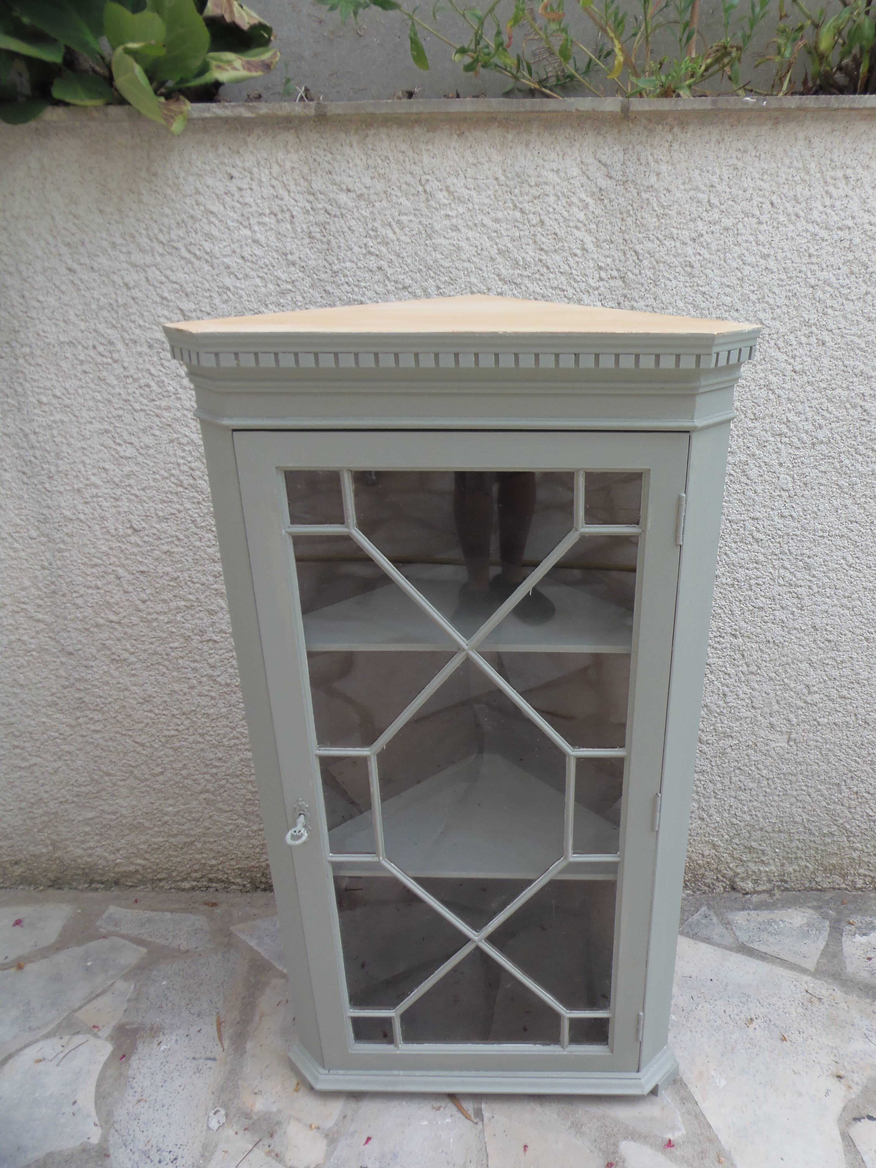 Vintage English corner display cabinet enhanced in grey-green with a wooden top.