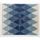 Tapis en laine contemporain avec des diamants bleus entrelacés.