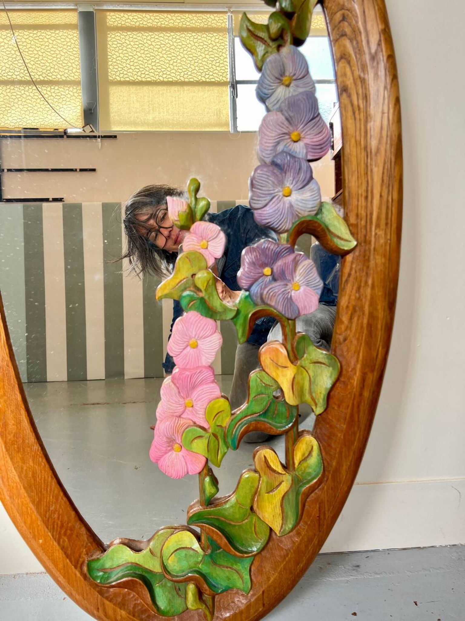 Carved wooden mirror with flower decorations.