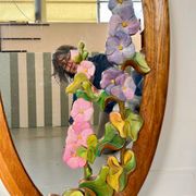 Carved wooden mirror with flower decorations.
