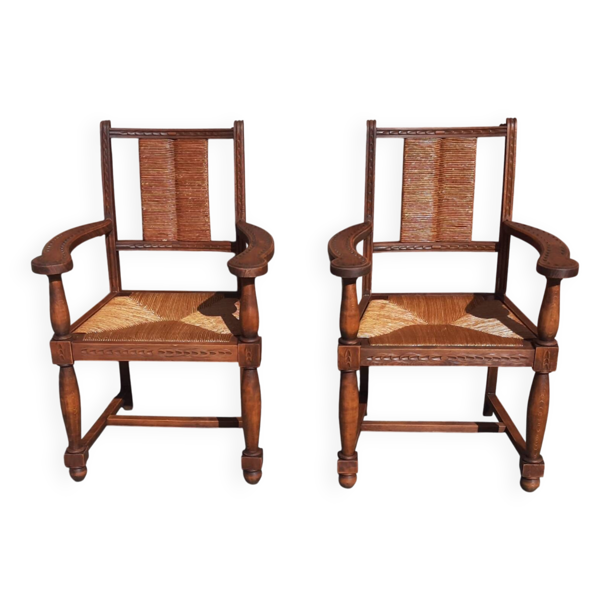 Pair of oak armchairs with straw seats and backs.