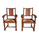 Pair of oak armchairs with straw seats and backs.