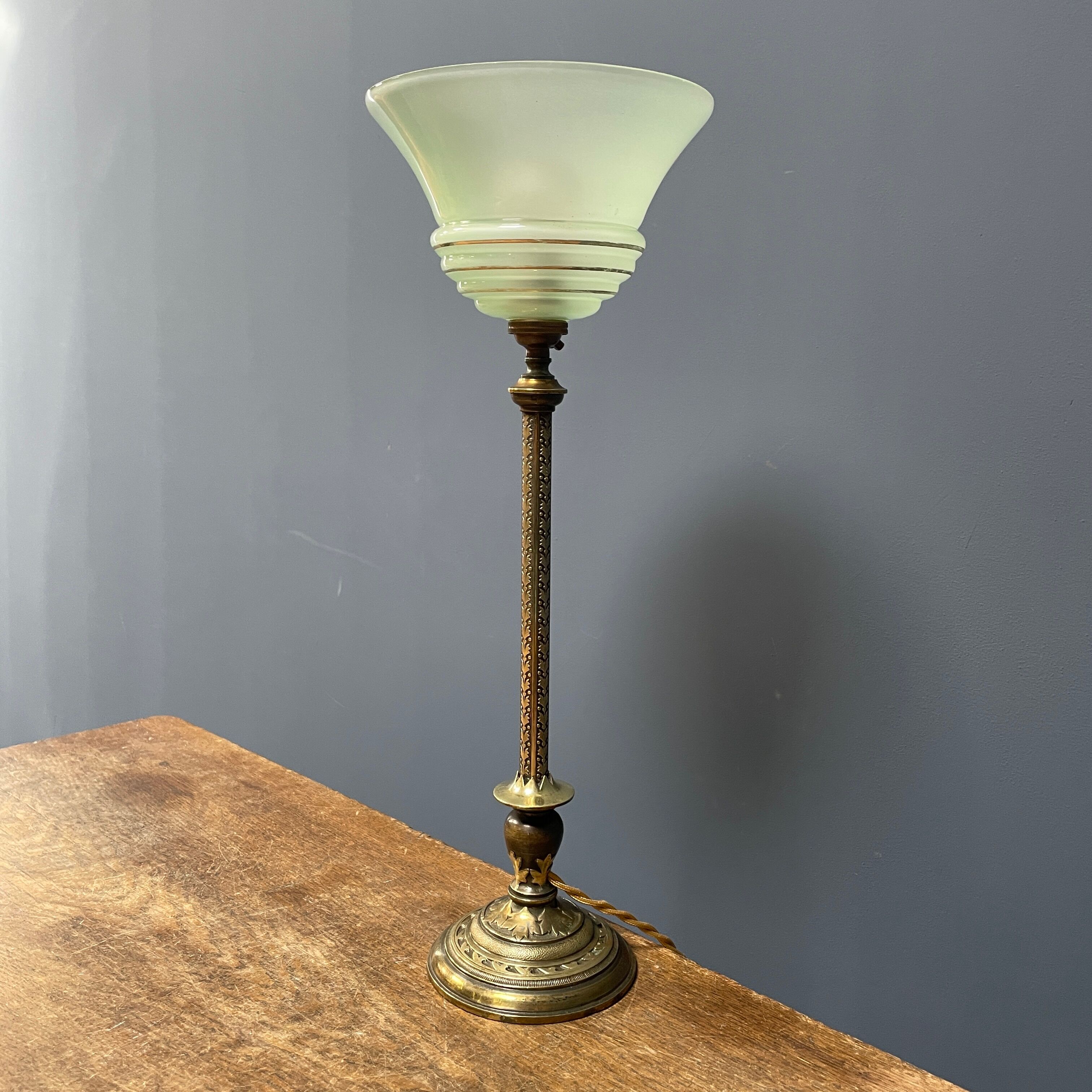 Ornate brass table lamp with mint green glass shade