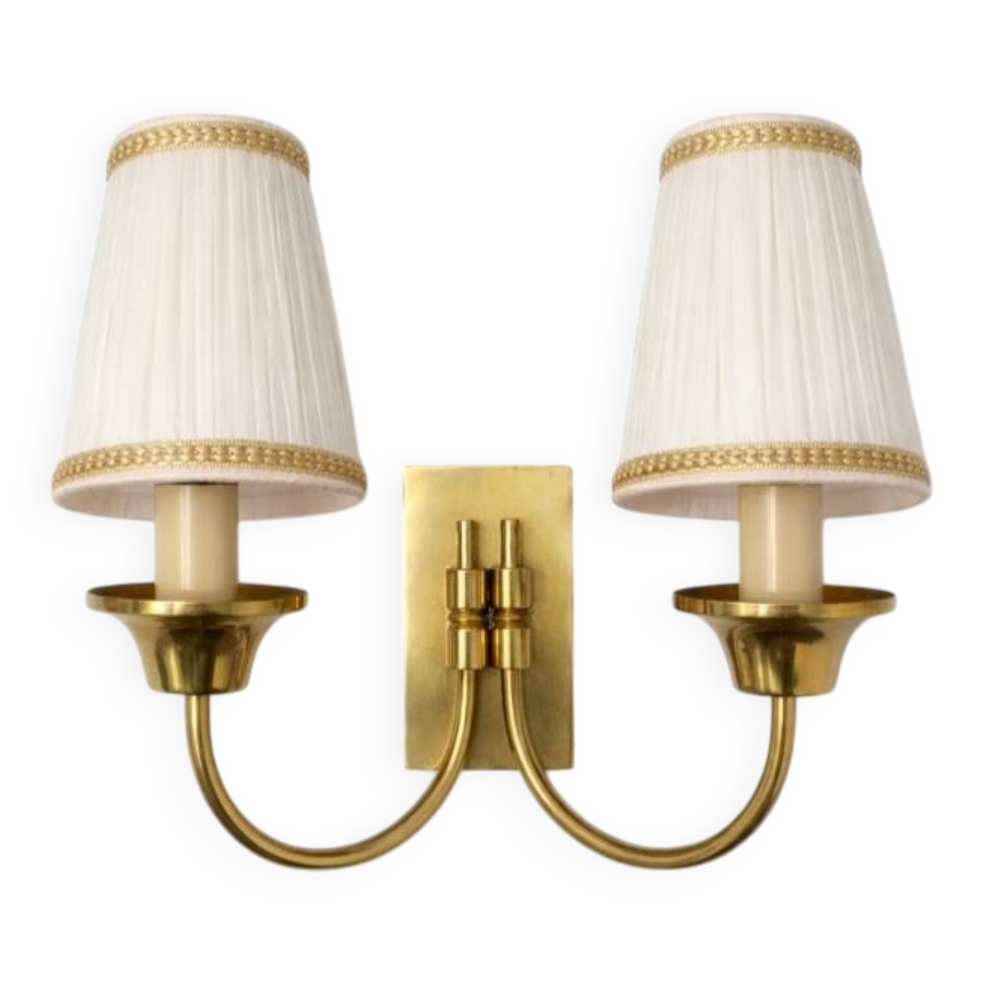 Vintage wall sconces in brass with pleated fabric shades.