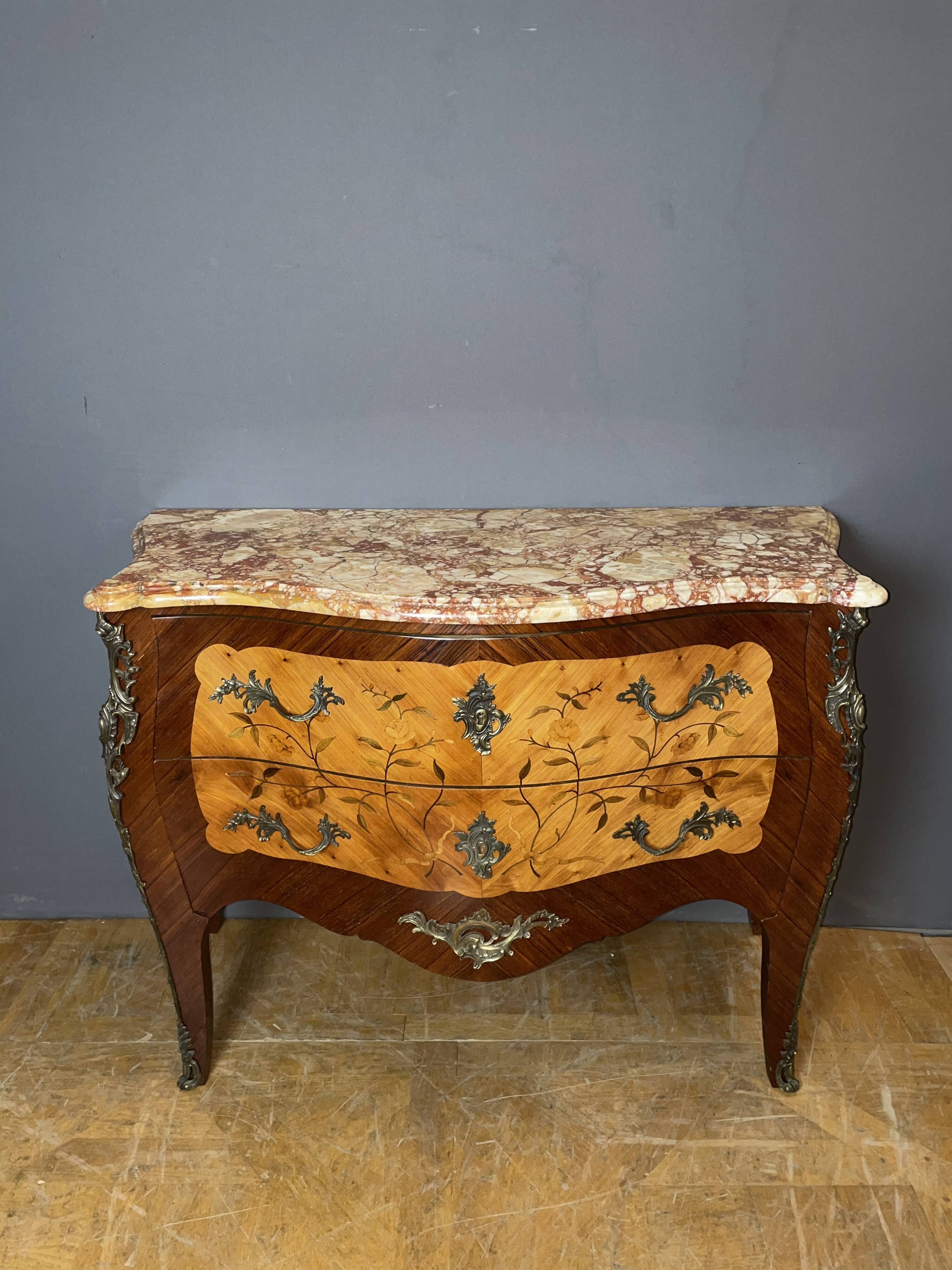 Louis XV style commode with floral marquetry decoration.