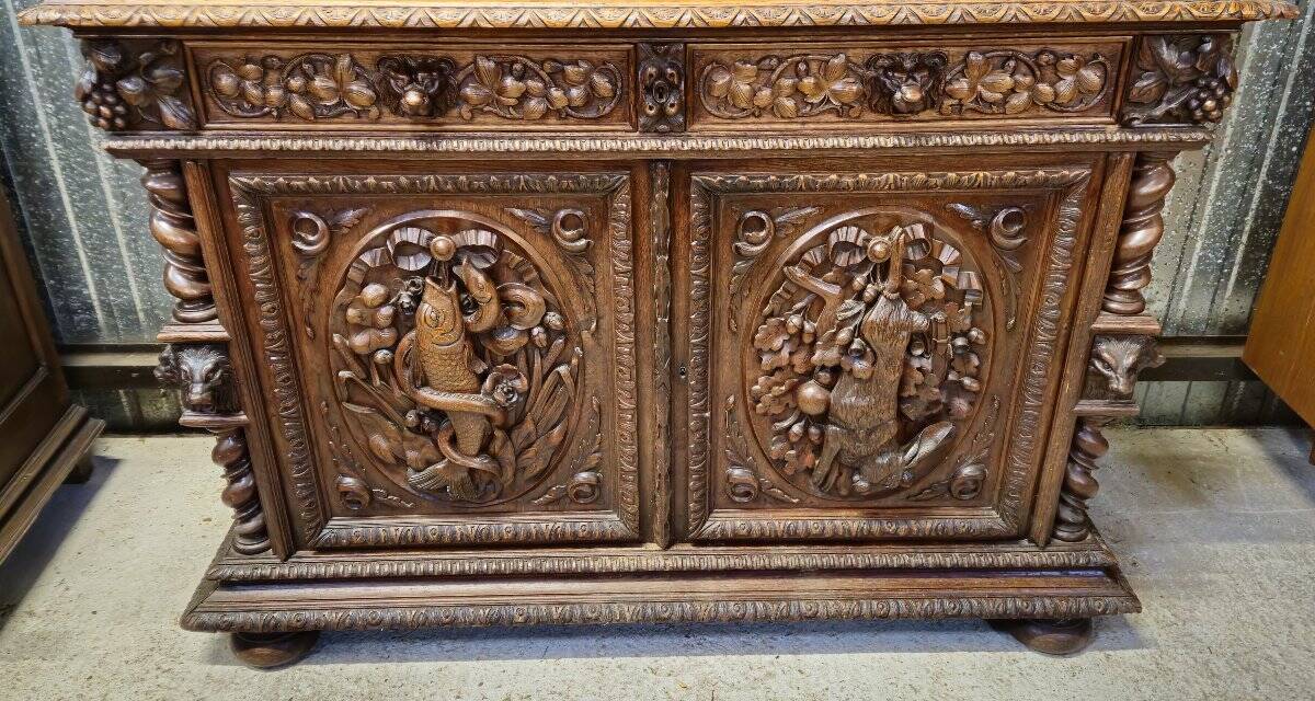 Two-body buffet in solid oak, richly carved in the Renaissance style.