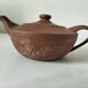 Japanese teapot in red clay engraved with integrated filter.