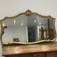 Large vintage mirror with an animated shape and Louis XV baroque style shell