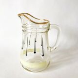 glass pitcher with black psyche patterns with gold edging from the 60s and 70s
