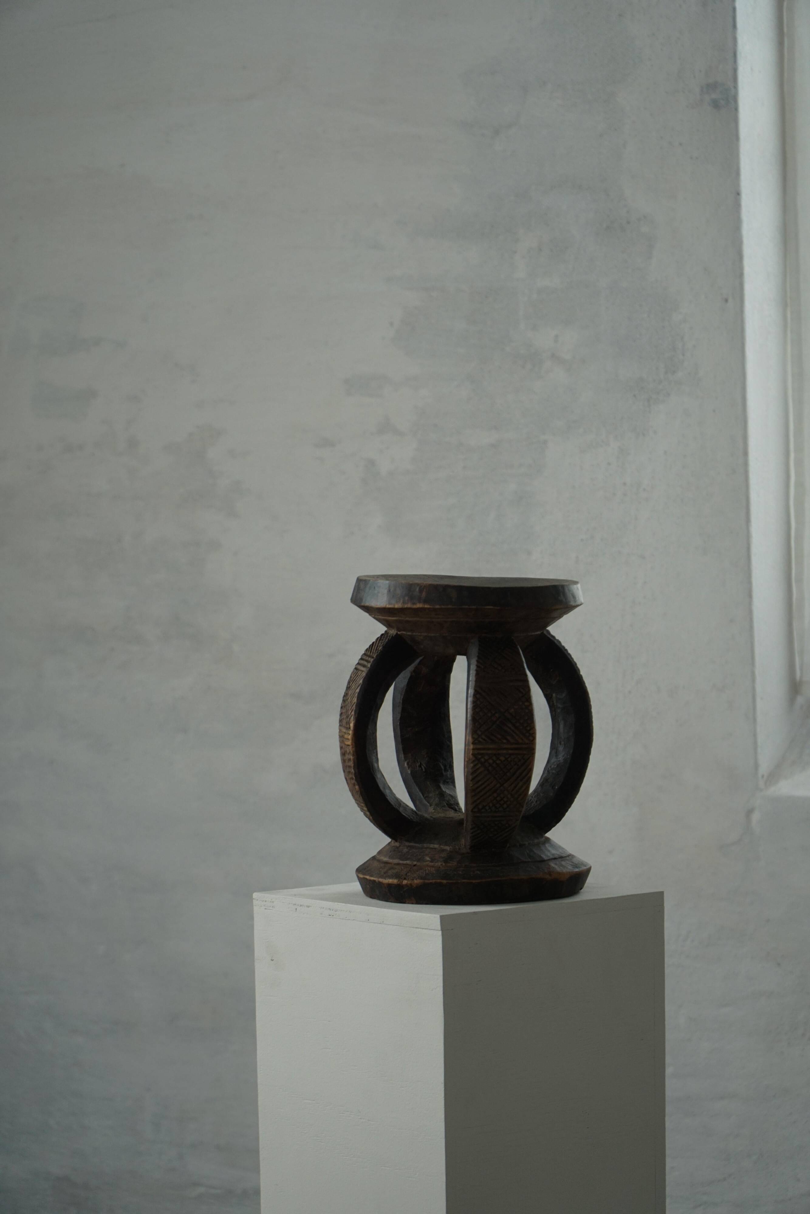 Antique wooden stool hand-carved by the Dogon people of Africa, Wabi-Sabi style, mid-20th century.