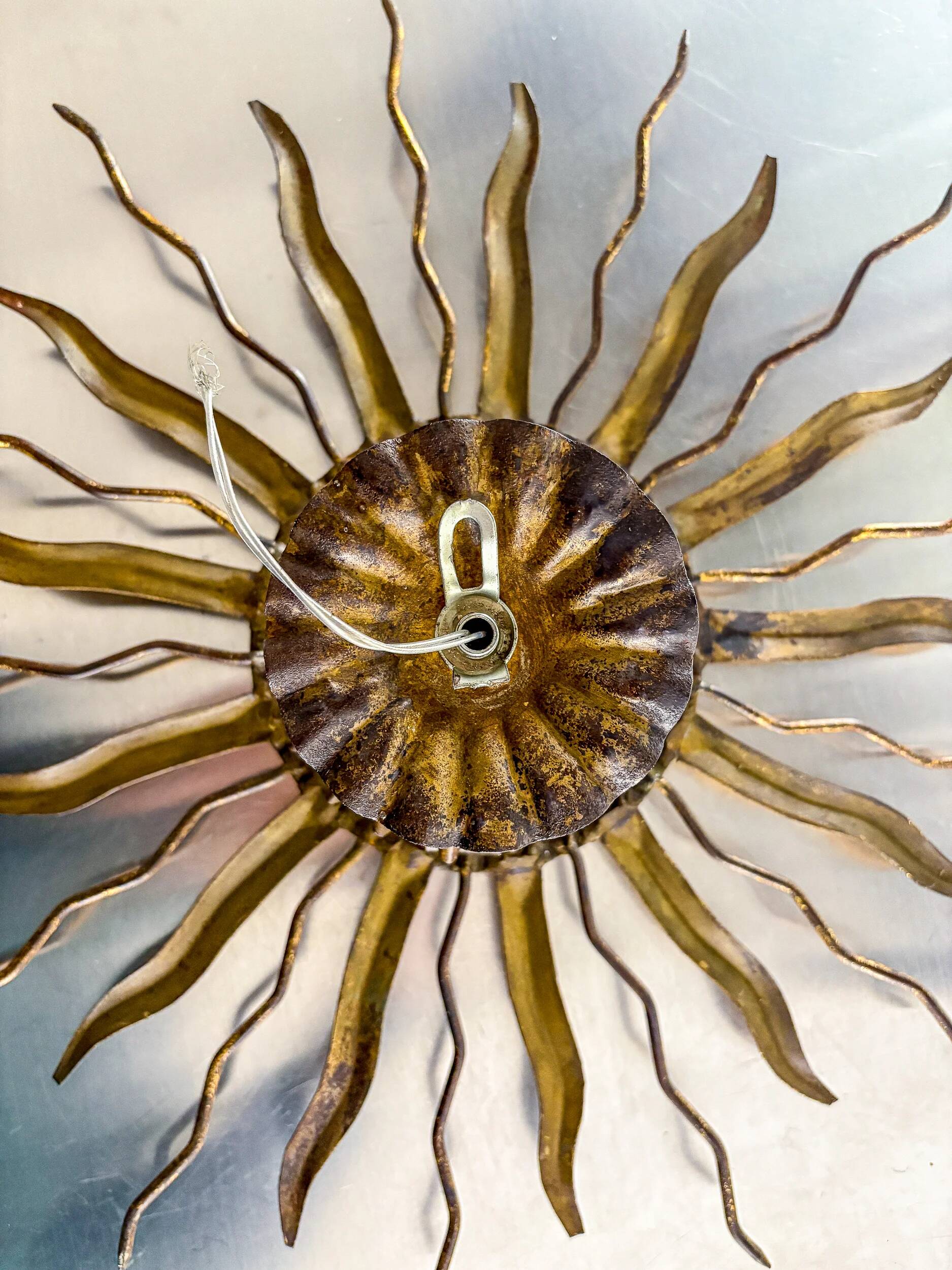 Brutalist sunburst ceiling light – gilt iron rays & exposed bulb, France, 1960s