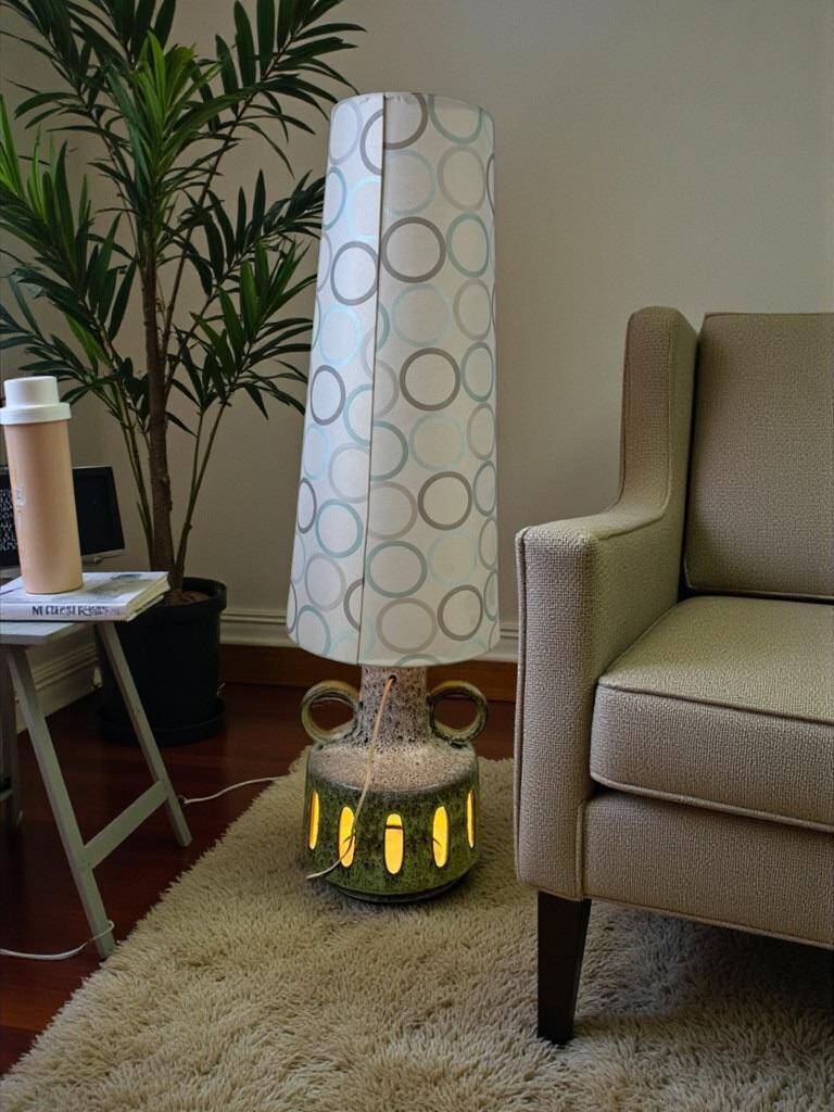 Vintage ceramic floor lamp with illuminated base.
