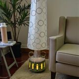 Vintage ceramic floor lamp with illuminated base.