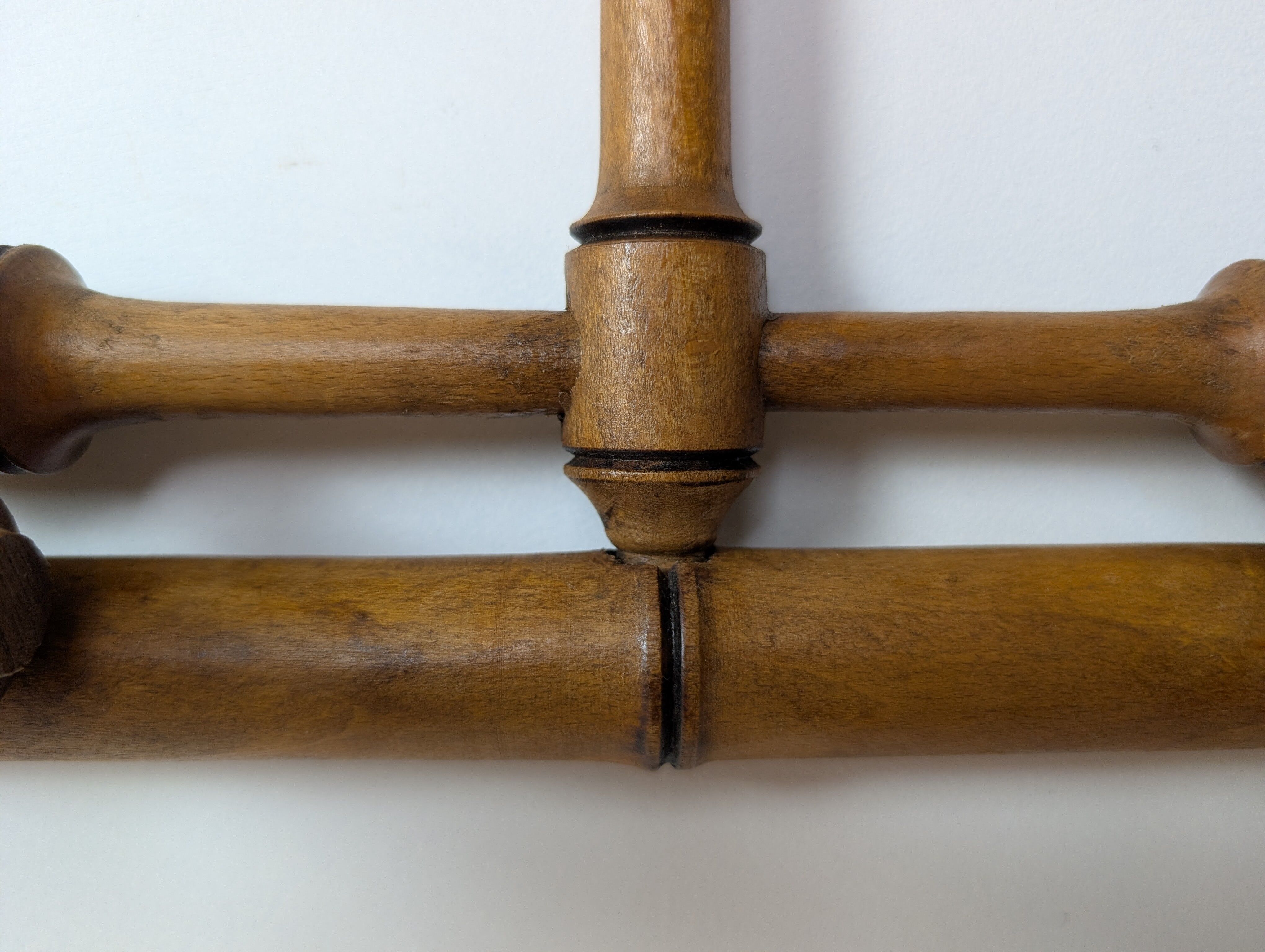 Wall-mounted coat rack made of turned wood