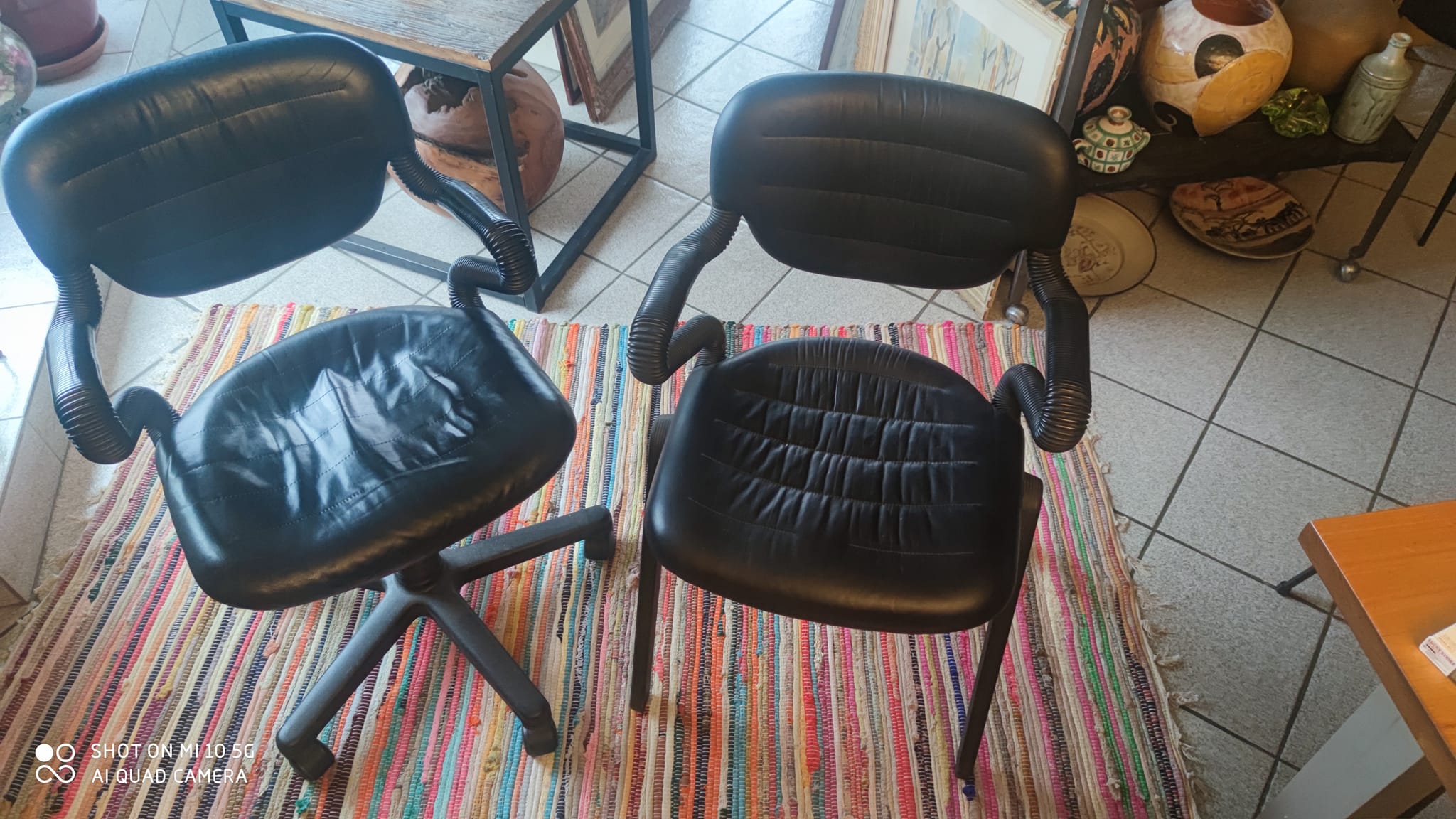 Two black leather armchairs