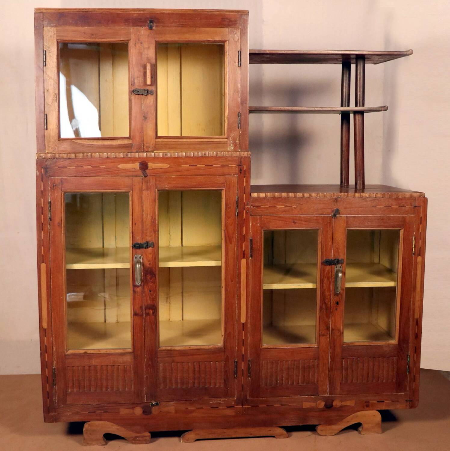 Antique Art Deco display cabinet in Burmese teak with original yellow patina interior.