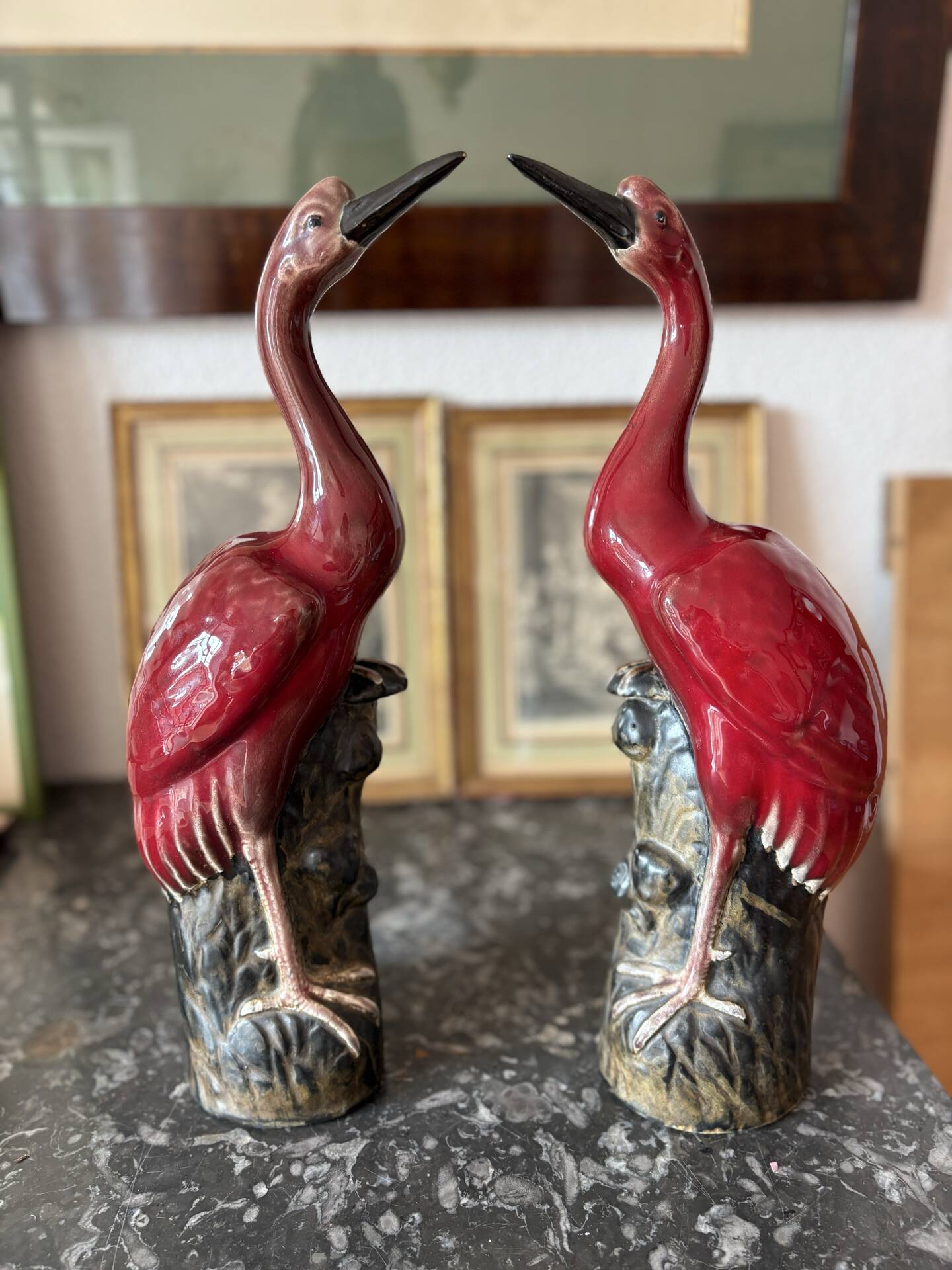 Pair of ceramic red glazed wading bird (crane) figurines.