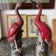 Pair of ceramic red glazed wading bird (crane) figurines.