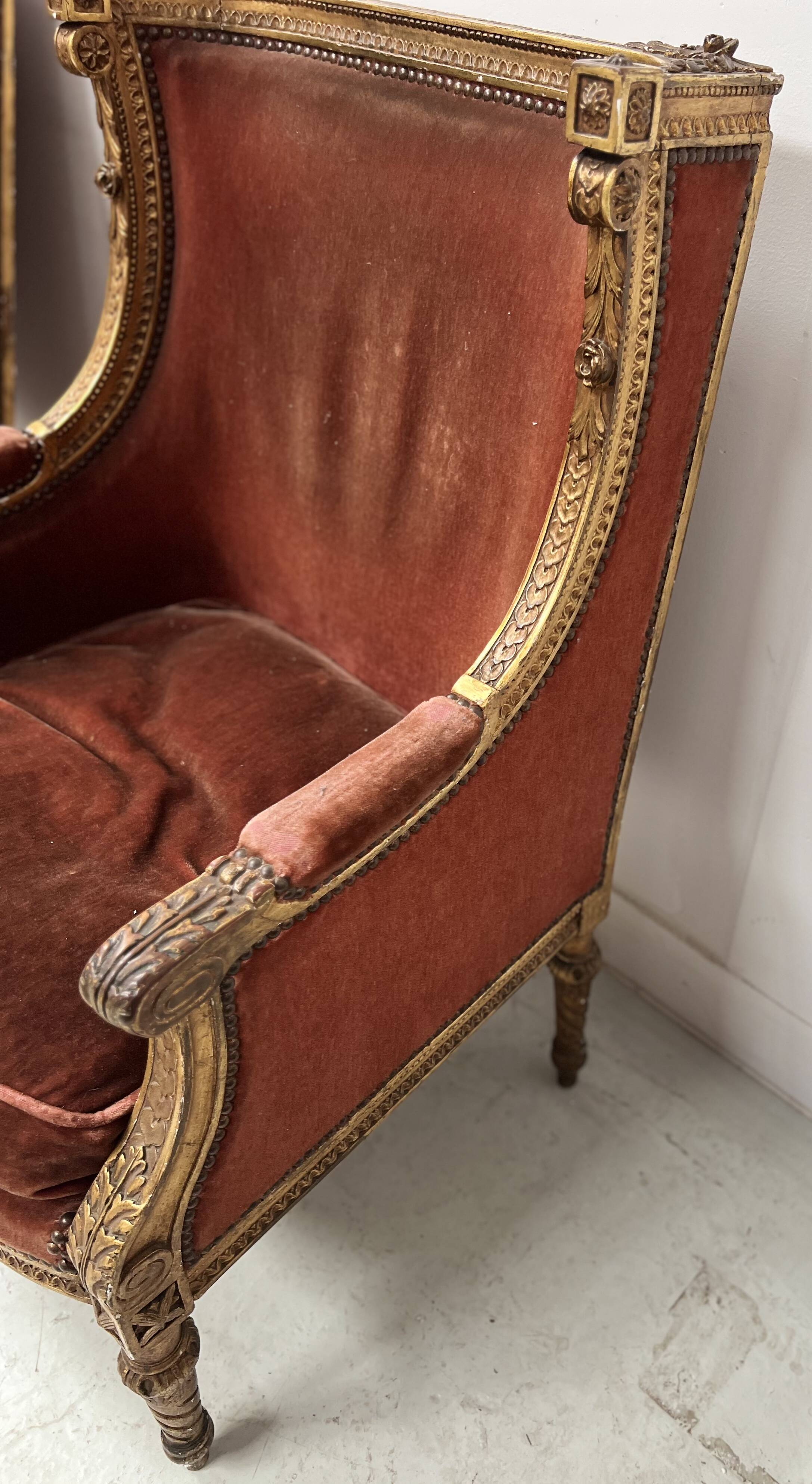 Two Louis XVI style wing chairs in gilded wood, 20th century