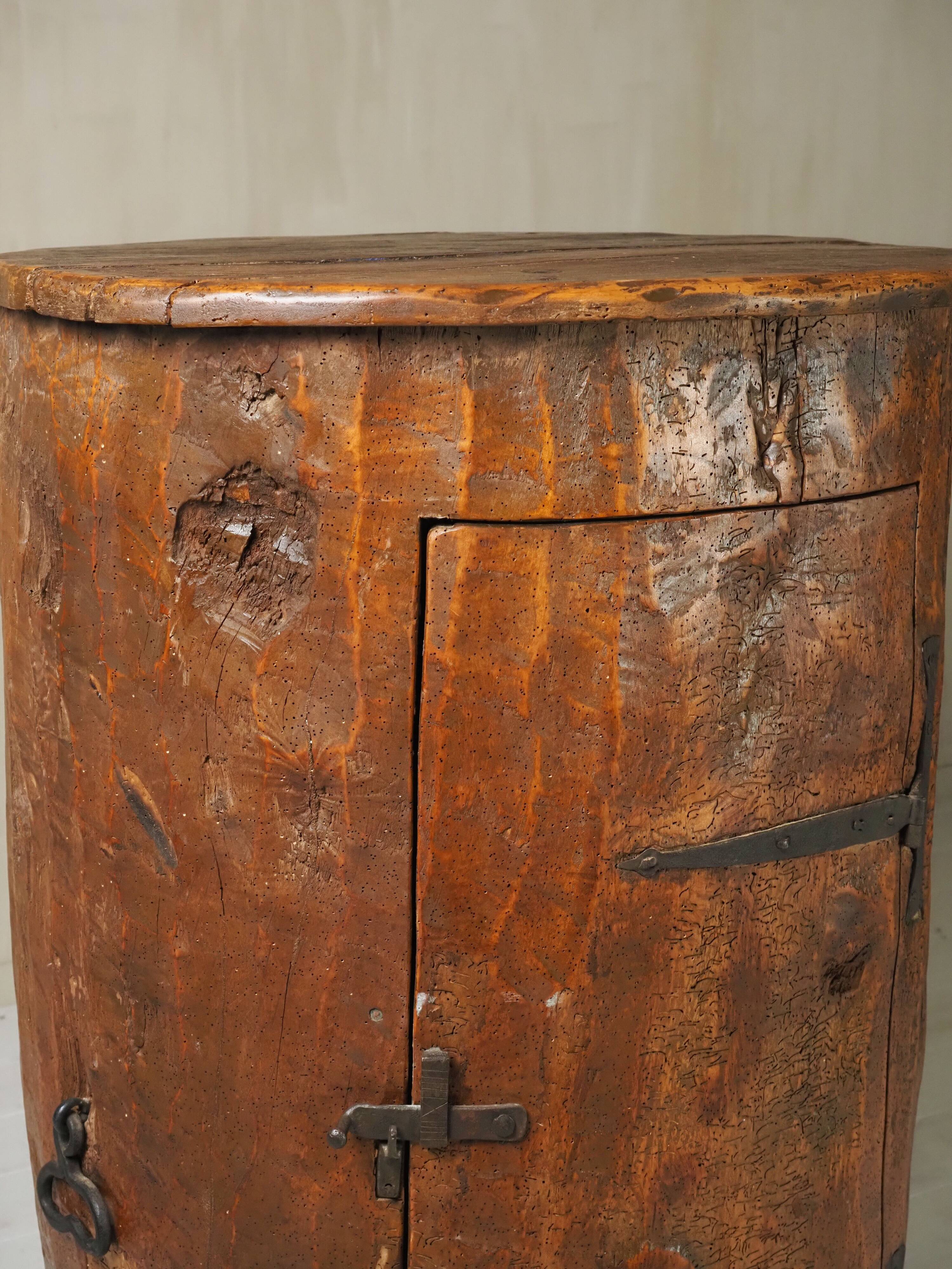 Primitive folk art cabinet made of an old tree trunk.