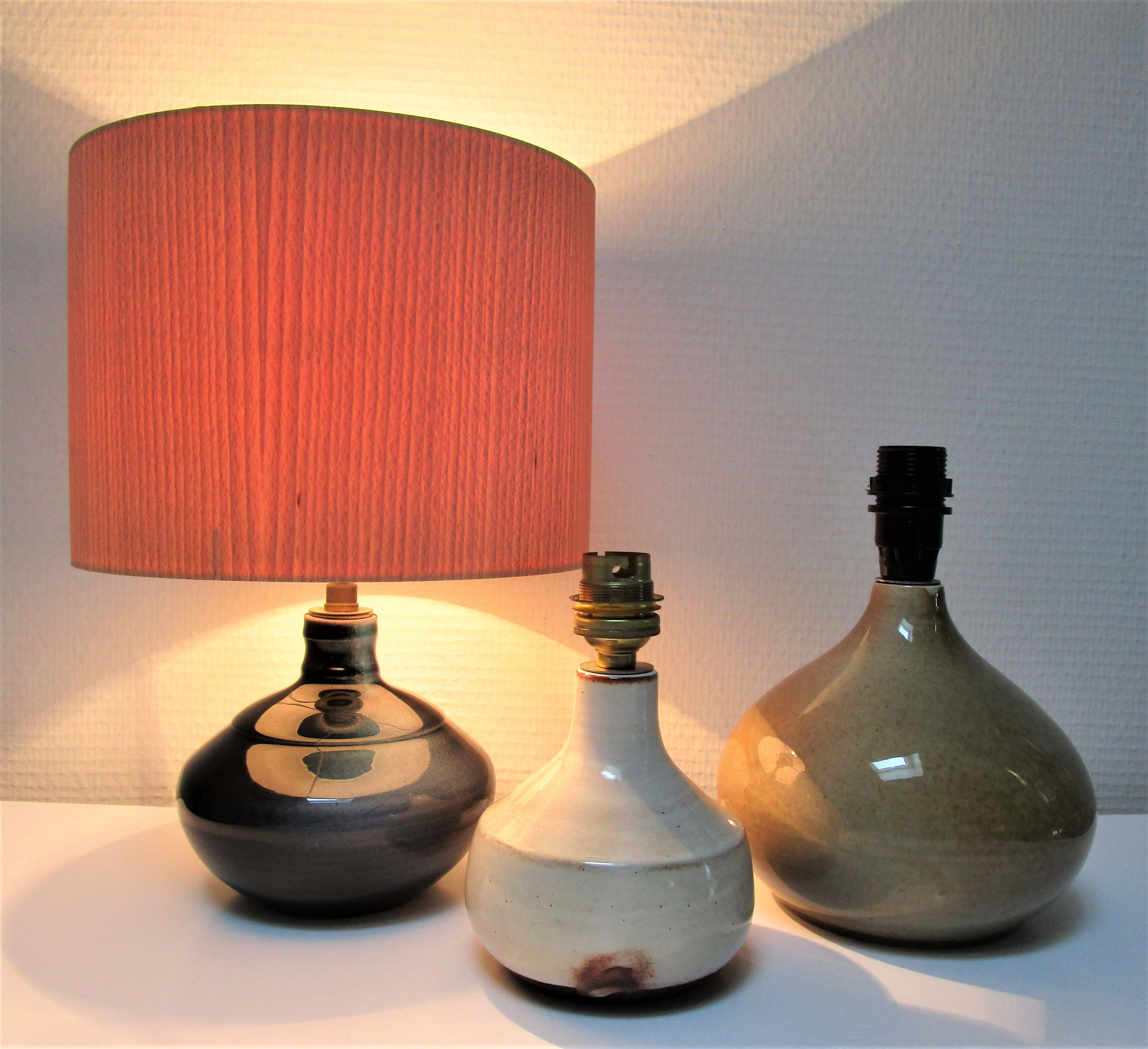 Three vintage ceramic lamps in blue, white and suede