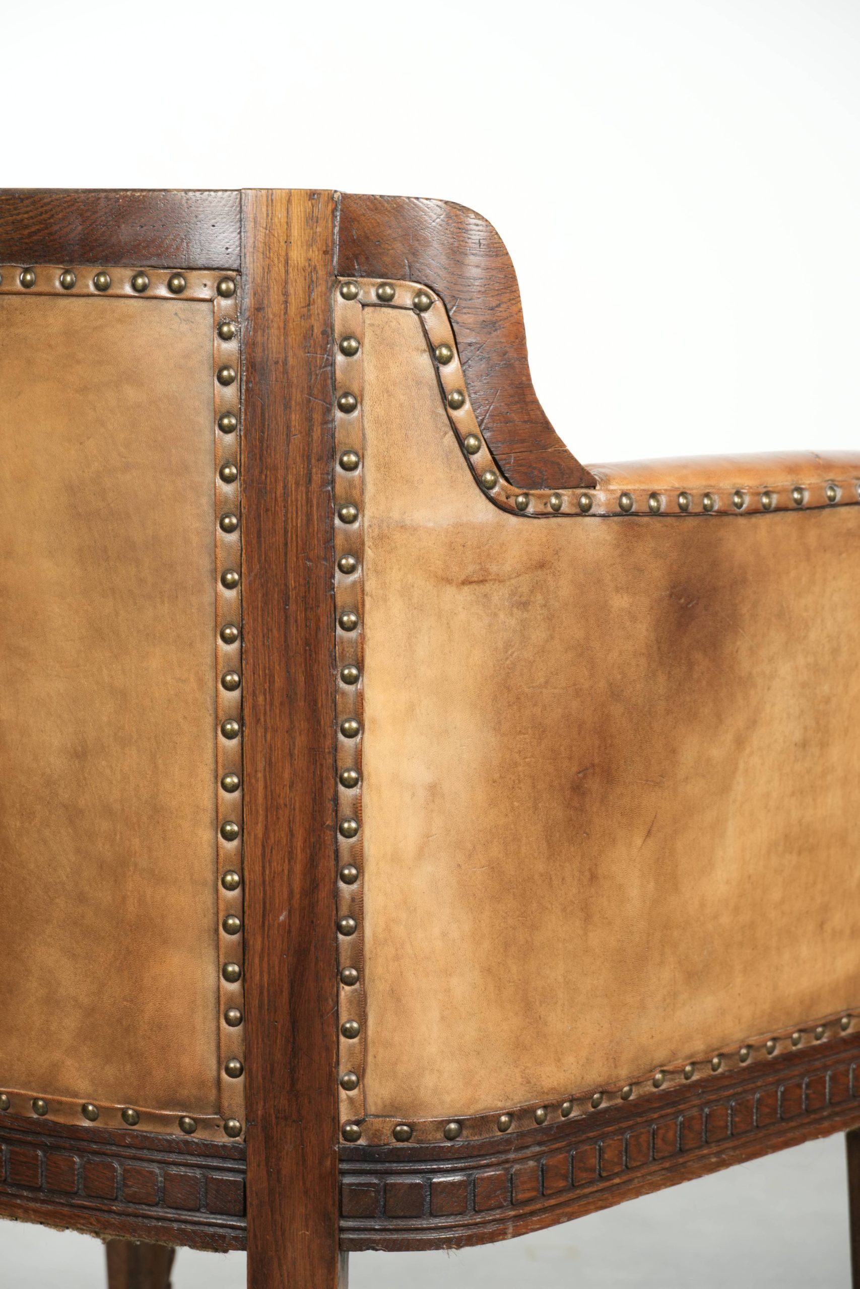 Antique armchair made of sheepskin and wood with decorative nails