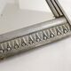 Art Deco mirror in silvered wood, stylised geometric frieze.