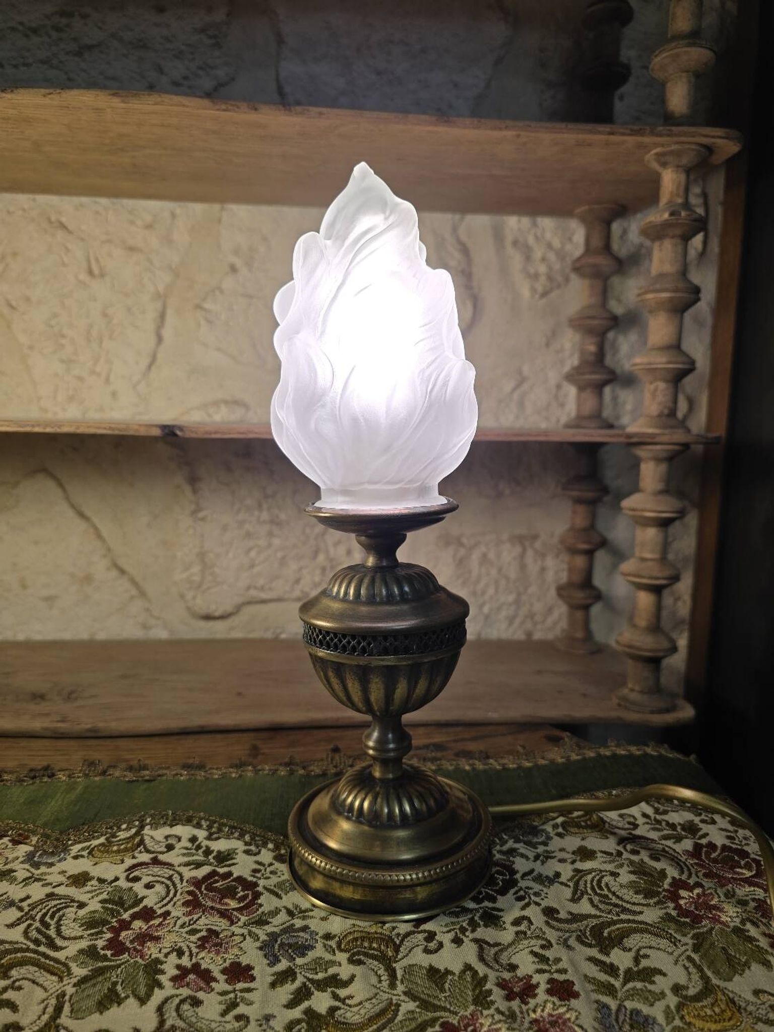 Small globe lamp with flame and brass base for oil.