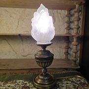 Small globe lamp with flame and brass base for oil.