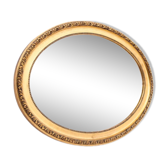 Oval mirror in a gold frame, France, first half of the 20th century.