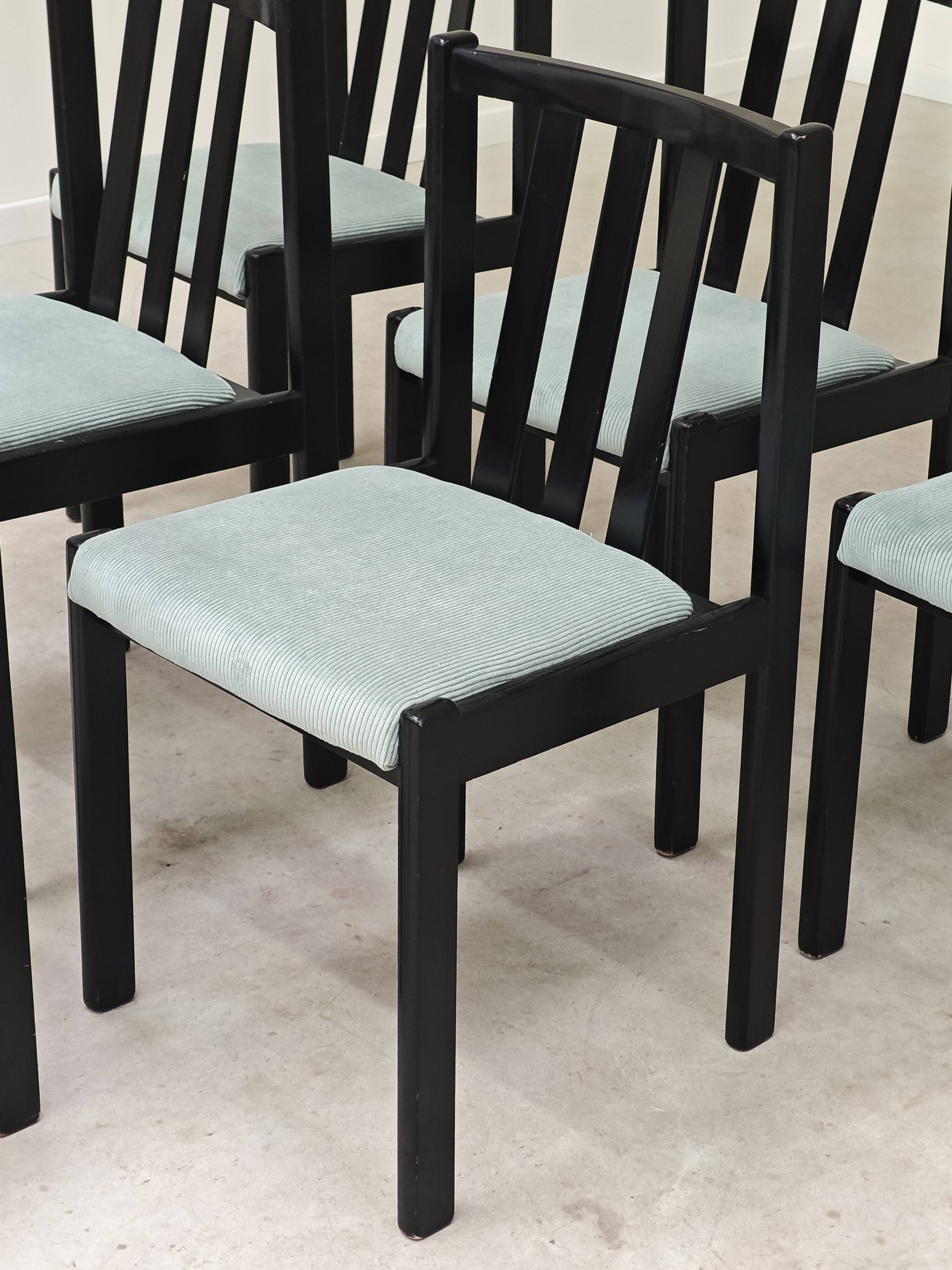 Set of 6 modernist black chairs with light blue-green ribbed fabric.
