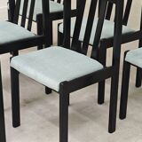 Set of 6 modernist black chairs with light blue-green ribbed fabric.