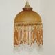 Vintage French amber mottled glass hanging ceiling light with beaded fringe.