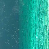 Solid glass desk with a half-moon top.